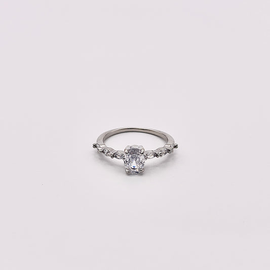 Front view of Odia, a charming oval zircon inlayed in a rhodium plated band.