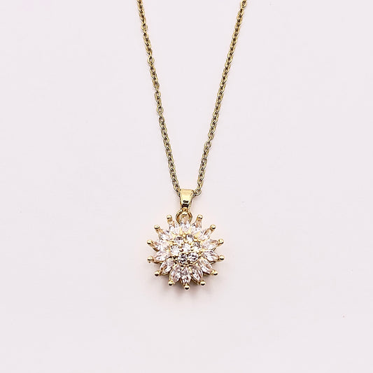 Close up front view of Ilio, a stunning gold plated rotating sunflower zircon necklace.