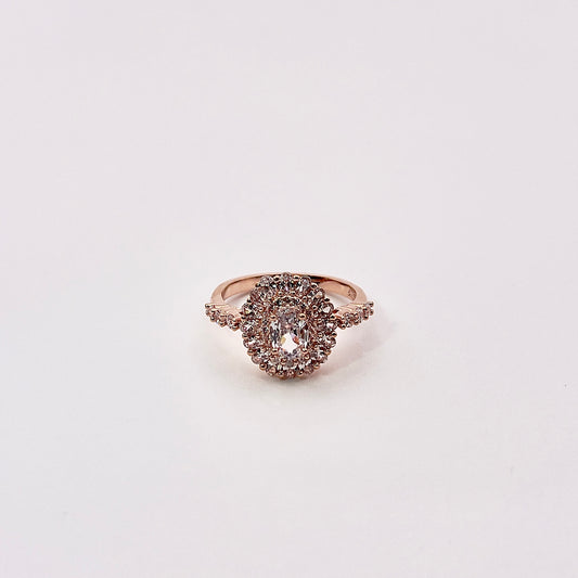 Front view of Afyl, a magnificent oval zircon cluster cradled in a warm rose gold band