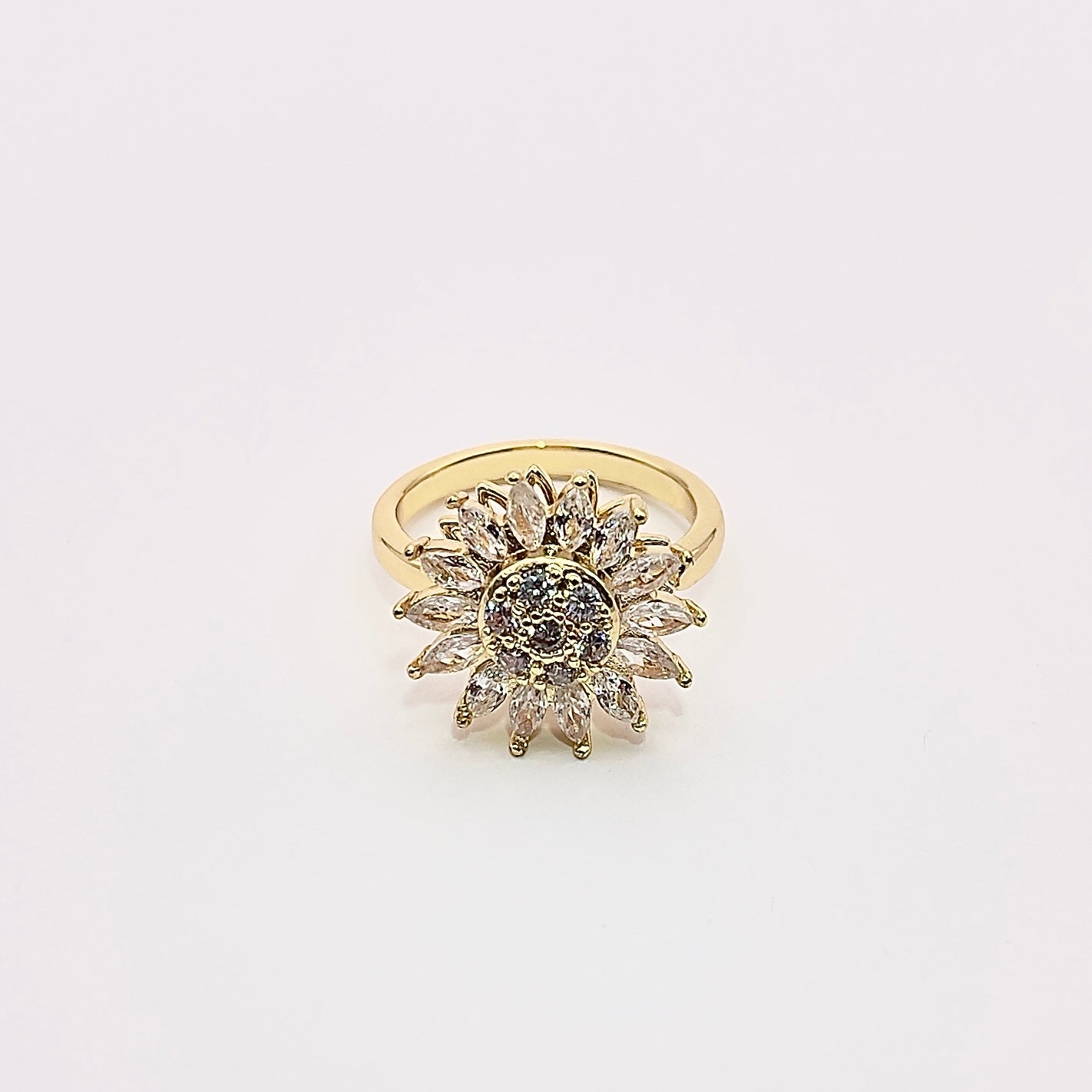 Front view of a stunning gold plated rotating sunflower zircon ring.