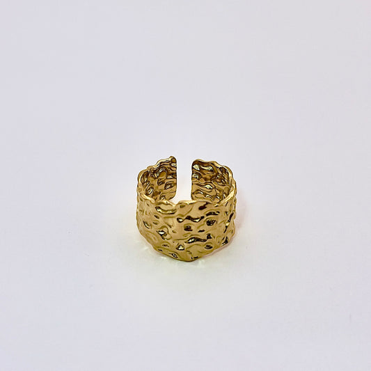 Front view of Atis, a mesmerizing wide gold plated ring evoking elements of the lake's surface.