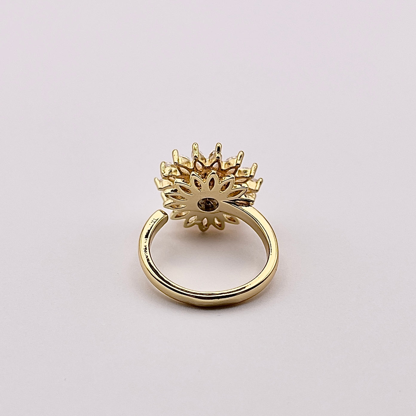 Back view of a stunning gold plated rotating sunflower zircon ring.